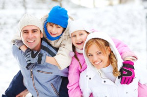 Beautiful family enjoying in snow and winter.